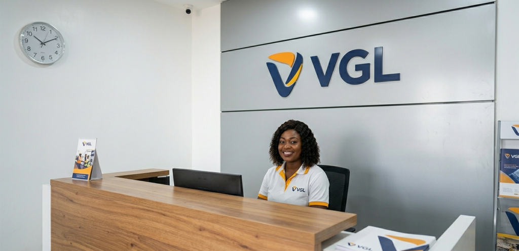 Confident young engineer wearing a hard hat and graduation stole celebrating academic achievement.